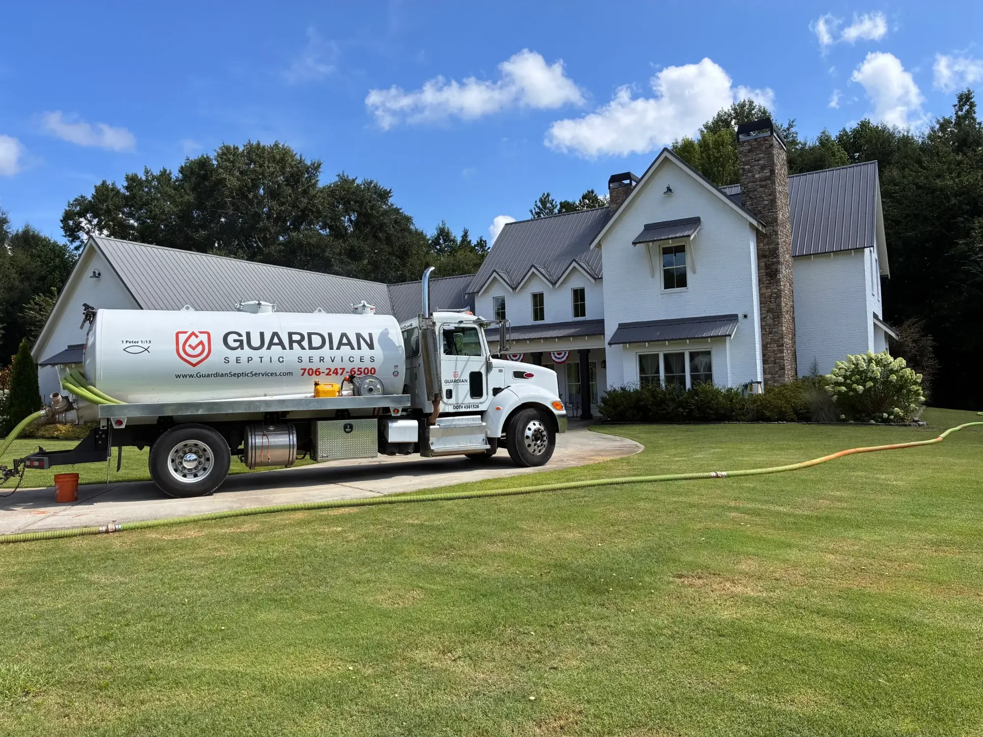 Guardian Septic Services vacuum truck pumping a septic tank at a Winder, Georgia home